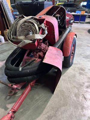 a red fire hydrant sitting in the middle of a garage