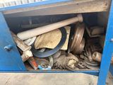 a blue metal cabinet filled with assorted items