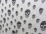 a shower curtain with skulls on it in a bathroom