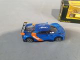 a toy car that is sitting on a table next to a box