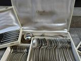 a lot of silverware in a case on the ground