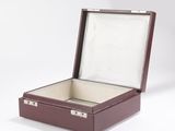a brown box with a silver lid on a white background