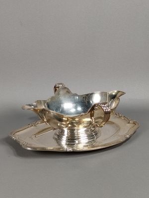 a silver plate with a silver bird on it