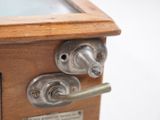 a close up of a wooden cabinet with a glass door