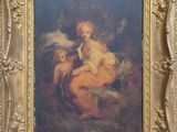 une peinture ancienne représentant une femme tenant un enfant dans ses bras