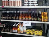 many bottles of liquid on the shelves in the store
