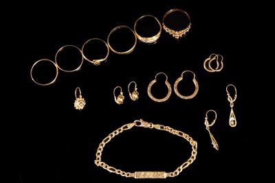 an assortment of gold jewelry including rings, bracelets, and rings
