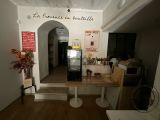 a room with a table and a refrigerator in it