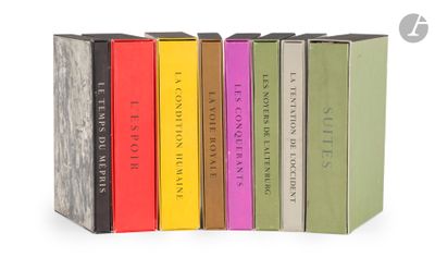 a group of books sitting on top of each other on a white surface