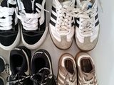 several pairs of shoes are lined up on a white surface