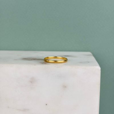 une bague en or posée sur un bloc de marbre