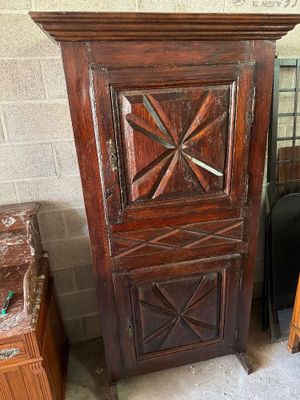 a tall wooden cabinet with a clock on top of it