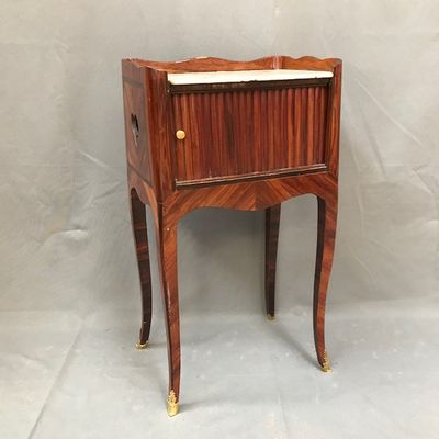 an image of a small wooden cabinet with a marble top