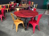 tables and chairs in a room with a clock on the wall