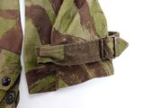 a close up of a camouflage jacket with a belt