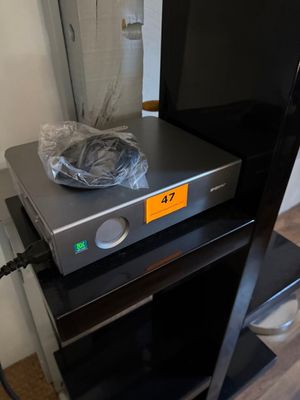 a flat screen tv sitting on top of a black stand