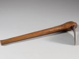 an old wooden hammer with a wooden handle sitting on a white surface
