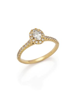 a diamond and gold ring with a pear shaped center