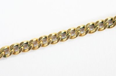 a close up of a gold chain on a white background