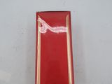 a red box with gold trim on a white surface