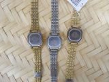 three watches sitting on top of a woven basket on top of a table