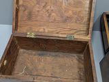 a wooden box sitting on top of a table next to a wooden ball