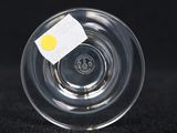 a clear glass bowl with a yellow label on it