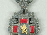 an image of a medal with a red cross and a gold lion on it