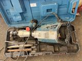 a blue tool box with tools in it on the ground