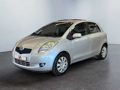 a picture of a silver toyota yaris parked in a showroom