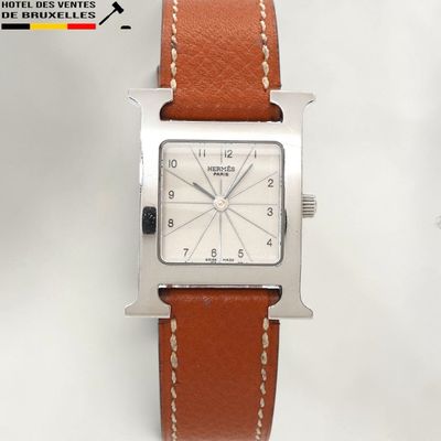 an image of a close up of a watch on a white surface