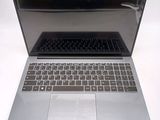 a silver laptop with a black keyboard on a white surface