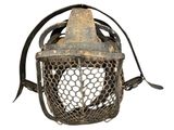 an old metal lantern with a wire mesh cover and a metal handle