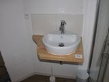 a small bathroom with a sink and a shower stall