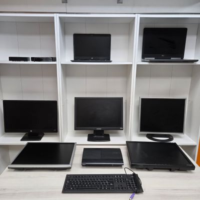 a desk with a keyboard, monitor, mouse, and monitor monitor on it