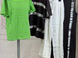 several shirts are hanging on a rack in a clothing store