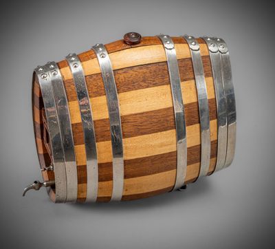 a wooden barrel with metal straps on a gray background