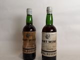 two bottles of port wine sitting next to each other on a table