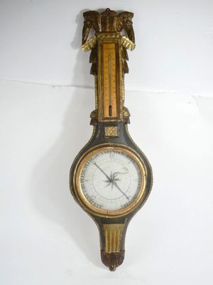 a clock hanging on the wall with an eagle on it