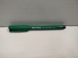 the green pen is laying on top of the white box