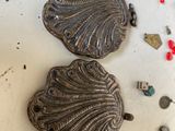 two shells on the table with other items on the table