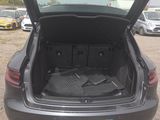 the back of a car with its trunk open in a parking lot