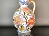 a vase with a floral design on it sitting on a table