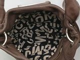 a brown purse with a black and white pattern on it