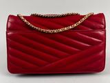 a red leather handbag with a gold chain on the handle