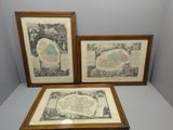 three framed maps of the world on display in a wooden frame