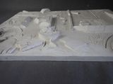 a white model of a building with a clock on it