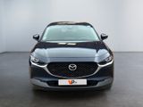 the mazda cx - hr is parked in a large room