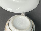 a small bowl with a lid that has a flower design on it