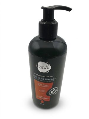 a black bottle of liquid with a black pump sitting on a white surface